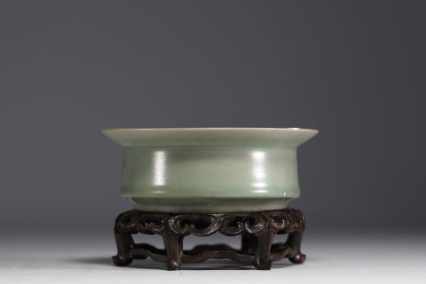 China - Celadon porcelain bowl on carved wooden base, Song dynasty.