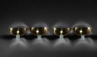 Set of four brass and green glass wall lights in the style of Jean Perzel.