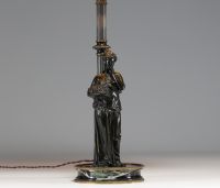 Bronze lamp depicting an antique woman leaning against a column, black marble base.