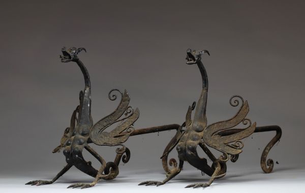 Paire de chenets zoomorphes en fer forgé, modèle aux dragons aux ailes déployées. 