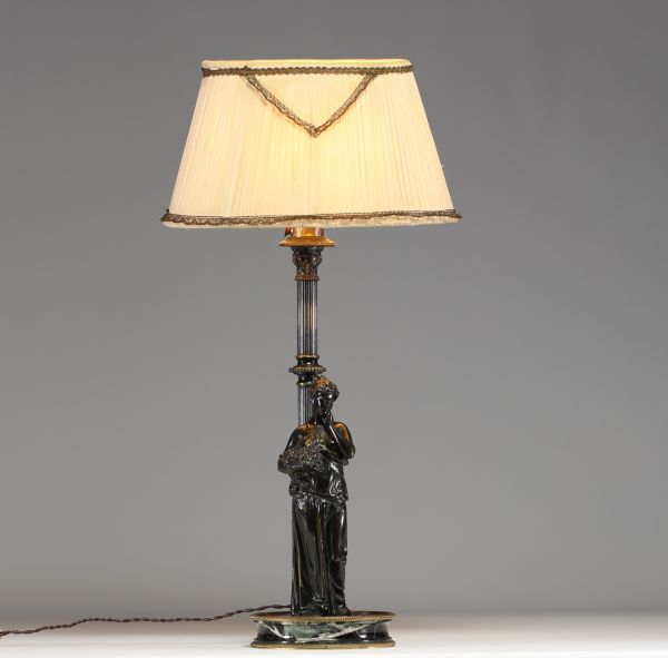 Bronze lamp depicting an antique woman leaning against a column, black marble base.