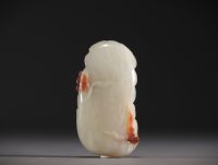 China - White and brown jade pendant with lotus flower and duck design.