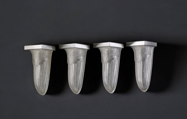 Suite of four Art Deco sconces in pressed moulded glass with stylised geometric decoration and nickel-plated metal, circa 1930.